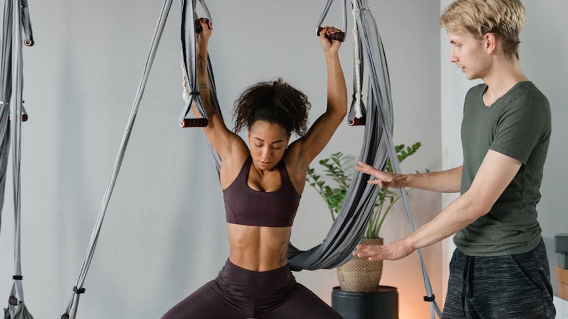 Active man practicing strength exercises in a bright room