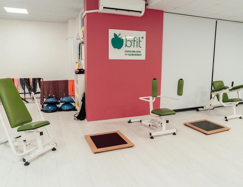 Professional gym atmosphere with clean equipment and soft lighting